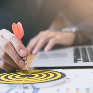 Business strategy success target goals. Businessman holding red dart push on target. Business strategy planning success target goals. Business development concept